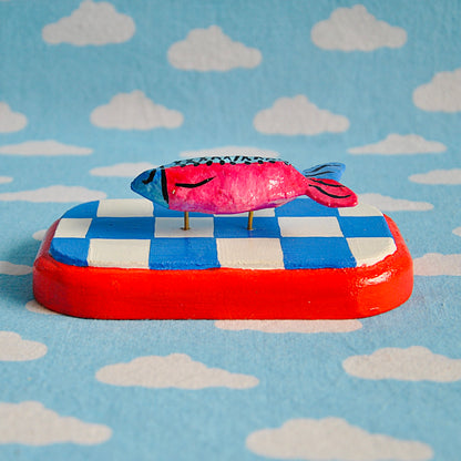 Tiny fish on checker board